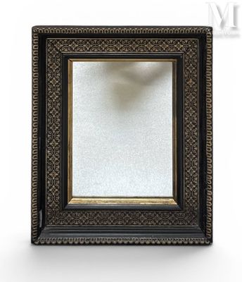 a close up of a black and gold picture frame on a white background