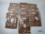 six bags of brown t - shirts sitting on top of a table