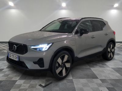 a grey volvo suv parked on a checkered floor in a garage