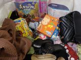 a pile of children ' s clothing and toys on a bed