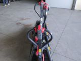 a red and black scooter sitting in a garage