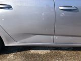 a silver car that is parked in a parking lot