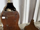 a small wooden clock with a bell on top of it