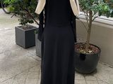 a mannequin in a black dress on a mannequin stand