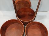 three wooden bowls with handles and handles on a white surface