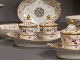 many different types of porcelain dishes and cups on the table
