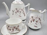 three pieces of porcelain tea and coffee set on a table