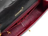 a close up of a black and red chanel bag