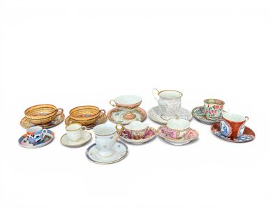 many cups and saucers that are sitting on a table