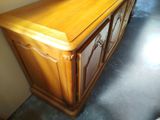 a wooden cabinet with a mirror on top of it