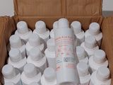 a cardboard box filled with white bottles and a bottle of water