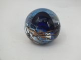 a glass ball with a painting on it on a table