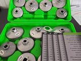 a lot of tools in a green case on a table