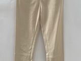 a pair of beige pants hanging on a hanger