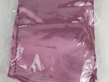 a pink cloth in a plastic bag on a table