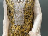 a mannequin wearing a yellow dress with a floral pattern on it