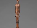 an image of a wooden pole with a figure on it