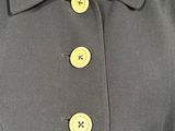 a close up of a dress with buttons on a mannequin mannequin mannequin mannequin mannequin mannequin mannequin mann