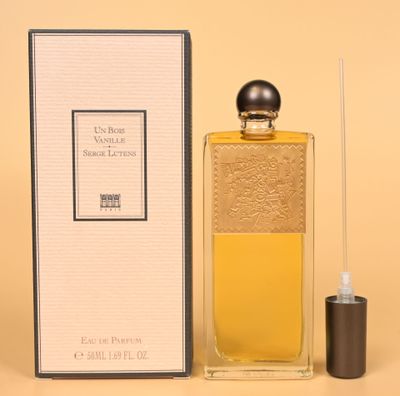 a close up of a bottle of perfume next to a box