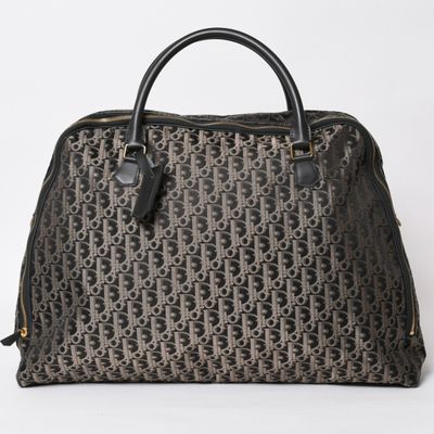 a brown and black handbag with a monogram pattern