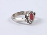 silver ring with a red stone in the middle of it