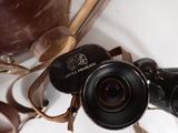 a brown bag and a pair of binoculars sitting on a table