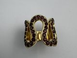 an image of a gold ring with garnets on a white surface