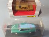 two toy cars in a clear box on a table