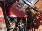 a red truck that has a steering wheel and a dashboard