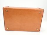 an image of a brown leather suitcase sitting on top of a white surface