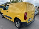 the yellow van is parked in a parking lot with other cars