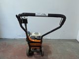 a small lawn mower that is sitting on the floor