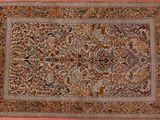 an antique persian rug with a floral design on a pink background
