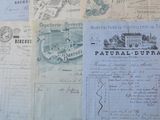 some old papers are sitting on a table with a blue table cloth