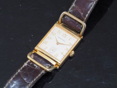 a watch that is sitting on a black surface