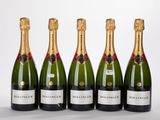 four bottles of champagne are lined up in a row