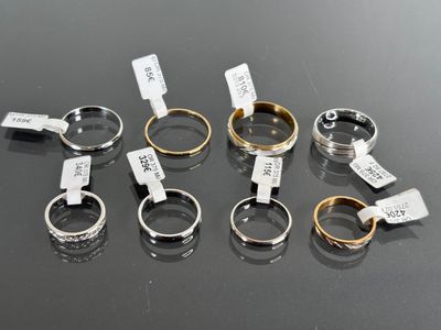 several different types of rings with tags on them on a table