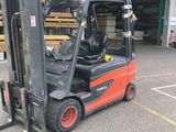 a fork lift truck parked in front of a warehouse