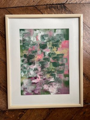 a painting of a green and pink abstract painting on a wooden floor