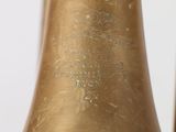 a close up of a brass bell on a white background