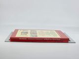 two books sitting on top of each other on a white surface