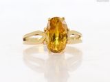 an image of a ring with a yellow sapphire stone on it