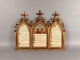 two gold colored crosses are on top of a gold colored wall