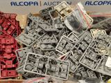 a pile of assorted plastic parts in a box
