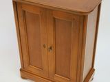 a small wooden cabinet with a door on top of it