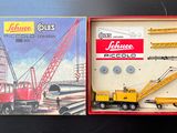 a box that has a toy truck and a crane in it