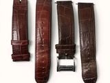 three pieces of brown alligator skin leather watch bands on a white surface