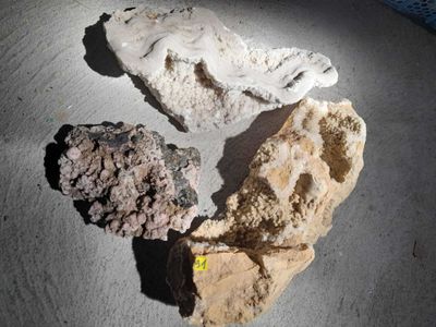 three pieces of rock sitting on top of a table next to each other