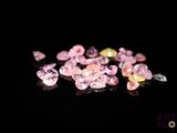 some pink and yellow diamonds are on a black surface