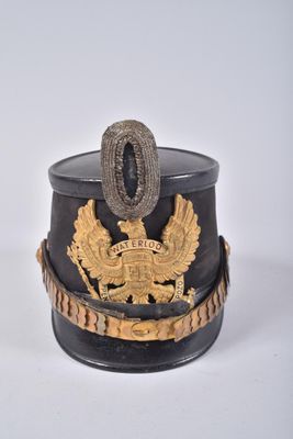 a black and gold hat with a gold eagle on it